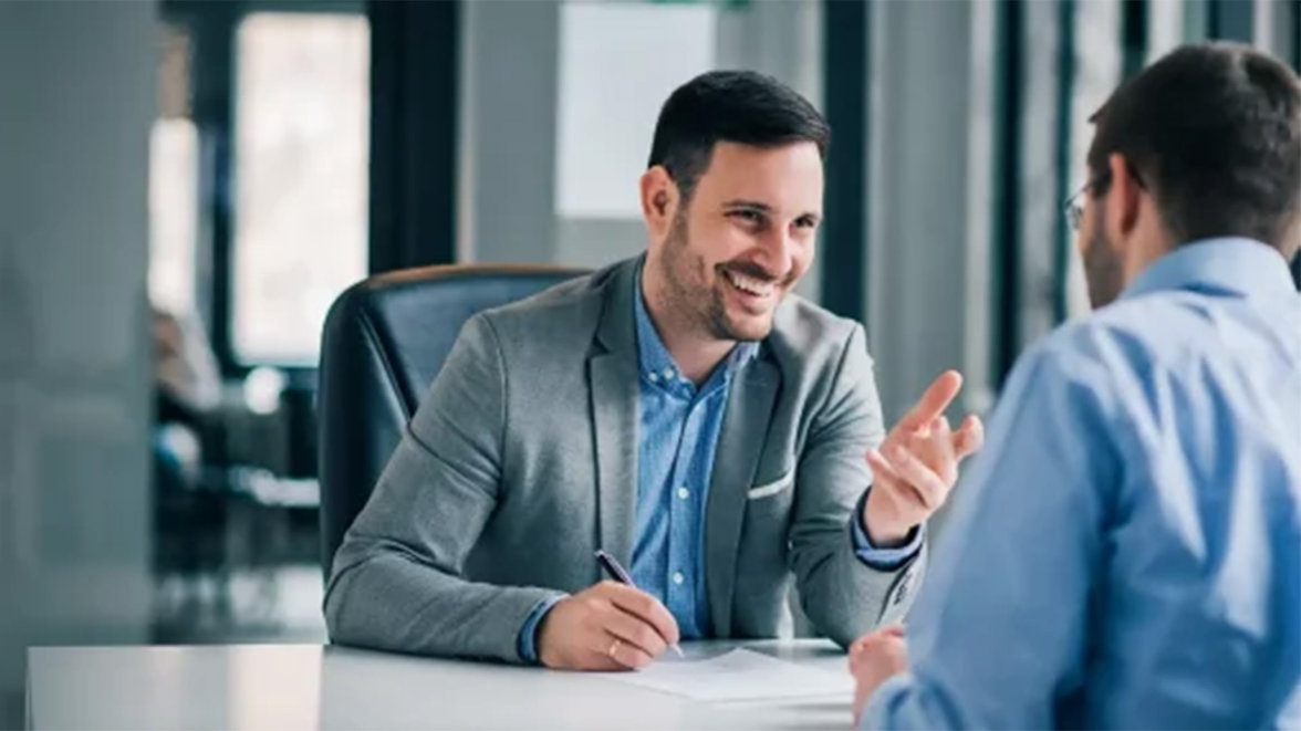 two man talking at the desk
